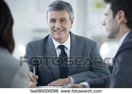 Businessman in meeting, portrait View Large Photo Image Stock Photo - Businessman in meeting, portrait. Fotosearch