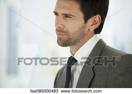 Businessman looking away in thought, portrait View Large Photo Image Stock Image - Businessman looking away in thought, portrait. Fotosearch