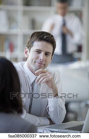 Stock Photo - Businessman meeting with client. Fotosearch