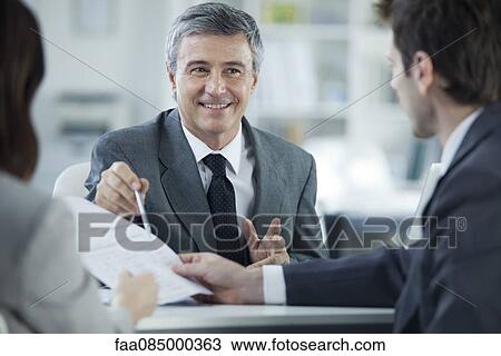 Stock Image - Businessman meeting with clients. Fotosearch