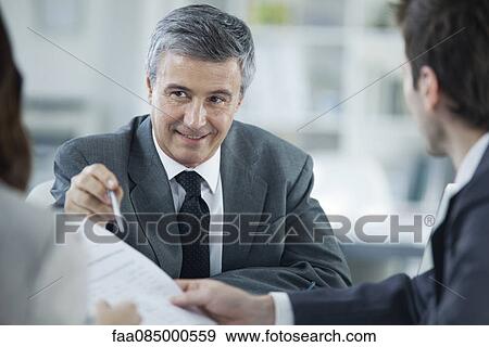 Stock Photo - Businessman meeting with clients. Fotosearch