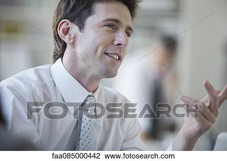 Businessman talking and smiling View Large Photo Image Stock Image - Businessman talking and smiling. Fotosearch