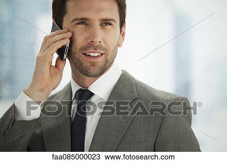 Businessman using cell phone, portrait View Large Photo Image Stock Image - Businessman using cell phone, portrait. Fotosearch