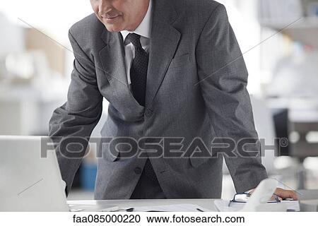 Businessman using laptop computer, cropped View Large Photo Image Stock Image - Businessman using laptop computer, cropped. Fotosearch