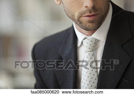 Stock Image - Businessman wearing suit and tie, cropped. Fotosearch