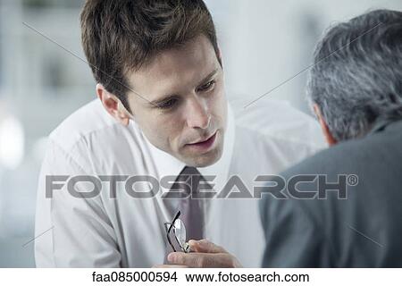 Picture - Businessmen discussing work. Fotosearch