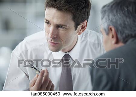Businessmen discussing work View Large Photo Image Stock Image - Businessmen discussing work. Fotosearch