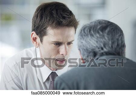 Businessmen discussing work View Large Photo Image Stock Photo - Businessmen discussing work. Fotosearch