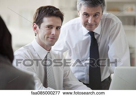 Businessmen working together, portrait View Large Photo Image Stock Photo - Businessmen working together, portrait. Fotosearch