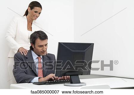 Businesswoman giving businessman massage at work View Large Photo Image Stock Photo - Businesswoman giving businessman massage at work. Fotosearch