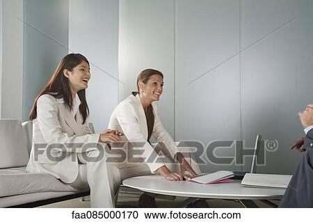Stock Image - Businesswomen in meeting. Fotosearch