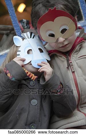 Stock Photograph - Children wearing animal masks, portrait. Fotosearch