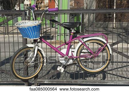 Picture - Child's bicycle locked on bicycle rack. Fotosearch