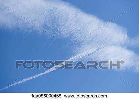 Clouds and vapor trail in blue sky View Large Photo Image Stock Photography - Clouds and vapor trail in blue sky. Fotosearch