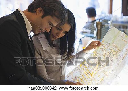 Couple looking at map together View Large Photo Image Stock Image - Couple looking at map together. Fotosearch