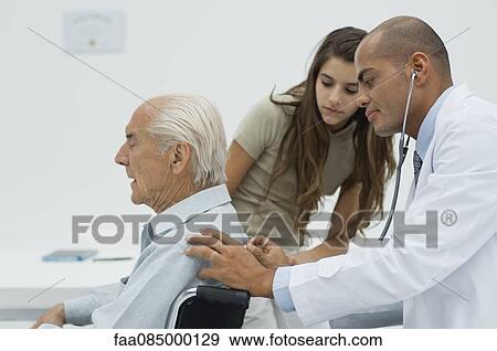 Stock Photo - Doctor examining elderly patient with stethoscope. Fotosearch