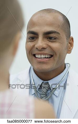 Stock Photo - Doctor examining young patient. Fotosearch