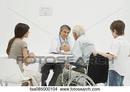 Picture - Doctor talking with senior patient and his family. Fotosearch