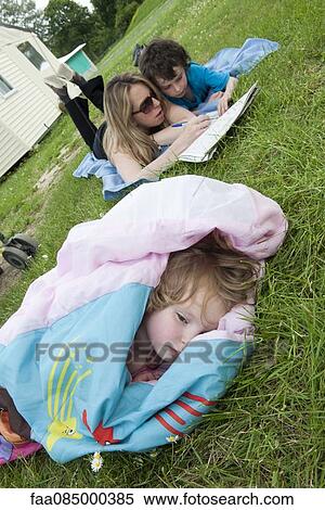 Family relaxing outdoors View Large Photo Image Stock Photography - Family relaxing outdoors. Fotosearch