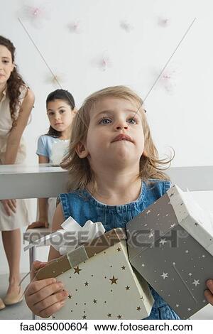Girl holding gifts View Large Photo Image Picture - Girl holding gifts. Fotosearch