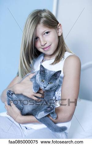 Stock Photography - Girl holding Russian Blue, portrait. Fotosearch