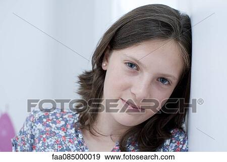 Girl leaning head against wall, portrait View Large Photo Image Stock Photo - Girl leaning head against wall, portrait. Fotosearch