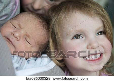 Stock Photo - Girl with baby brother, portrait. Fotosearch