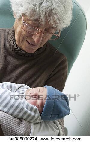 Picture - Grandmother holding newborn baby. Fotosearch