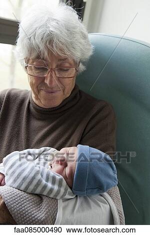 Stock Image - Grandmother holding newborn baby. Fotosearch