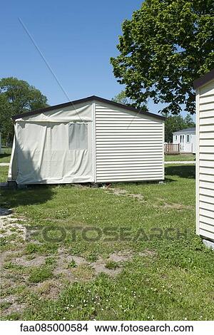 Picture - House with porch covered by tent flaps. Fotosearch