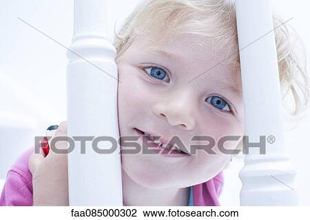 Little boy looking through banister, portrait View Large Photo Image Stock Image - Little boy looking through banister, portrait. Fotosearch