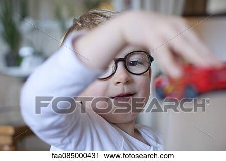 Stock Image - Little boy playing with toy. Fotosearch
