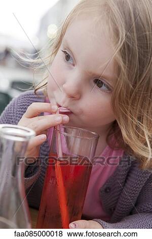 Little girl drinking beverage with straw View Large Photo Image Stock Photo - Little girl drinking beverage with straw. Fotosearch