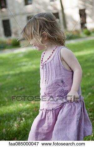 Stock Photo - Little girl having fun outdoors. Fotosearch