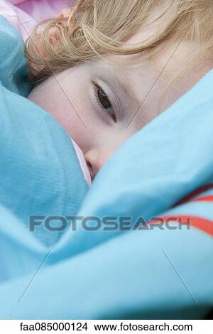 Picture - Little girl napping with blanket, close-up. Fotosearch