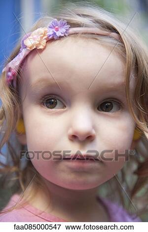 Stock Photo - Little girl wearing headband, portrait. Fotosearch