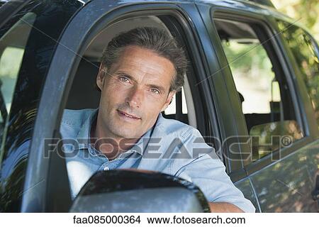 Picture - Man in car, portrait. Fotosearch