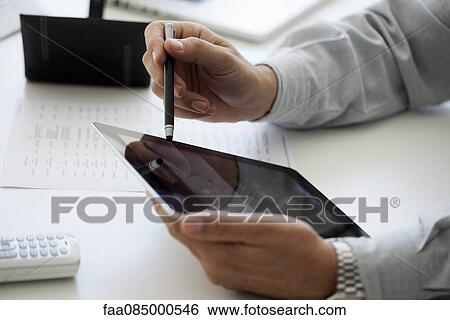 Man using digital tablet and stylus, cropped View Large Photo Image Stock Photograph - Man using digital tablet and stylus, cropped. Fotosearch