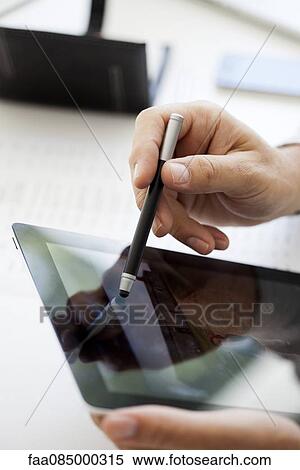 Man using digital tablet and stylus, cropped View Large Photo Image Stock Photography - Man using digital tablet and stylus, cropped. Fotosearch