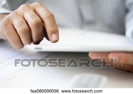Man's hands holding digital tablet, cropped View Large Photo Image Stock Photograph - Man's hands holding digital tablet, cropped. Fotosearch