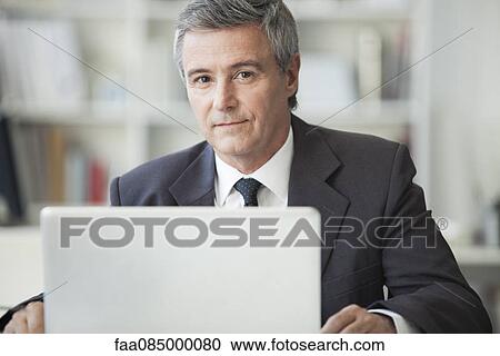Mature businessman in office, portrait View Large Photo Image Stock Image - Mature businessman in office, portrait. Fotosearch