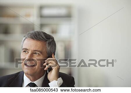 Mature businessman talking on cell phone View Large Photo Image Stock Image - Mature businessman talking on cell phone. Fotosearch