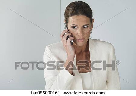 Mature businesswoman talking on cell phone View Large Photo Image Stock Image - Mature businesswoman talking on cell phone. Fotosearch