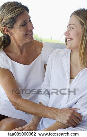 Mother and adult daughter embracing View Large Photo Image Stock Image - Mother and adult daughter embracing. Fotosearch