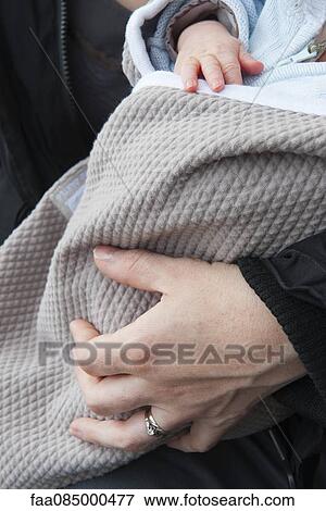 Mother holding baby, cropped View Large Photo Image Stock Photo - Mother holding baby, cropped. Fotosearch
