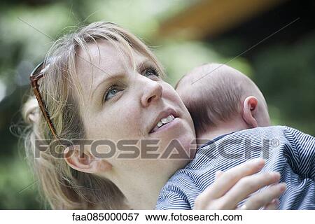Mother holding baby View Large Photo Image Stock Photo - Mother holding baby. Fotosearch