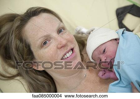Mother holding newborn baby View Large Photo Image Picture - Mother holding newborn baby. Fotosearch