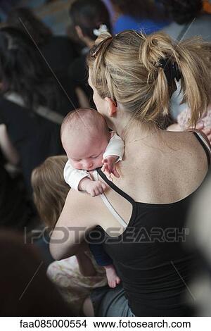 Mother holding sleeping baby, rear view View Large Photo Image Picture - Mother holding sleeping baby, rear view. Fotosearch