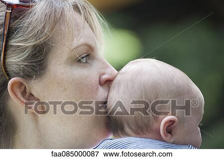 Stock Photo - Mother kissing baby. Fotosearch