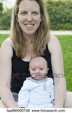 Mother sitting outdoors with baby boy, portrait View Large Photo Image Stock Photo - Mother sitting outdoors with baby boy, portrait. Fotosearch